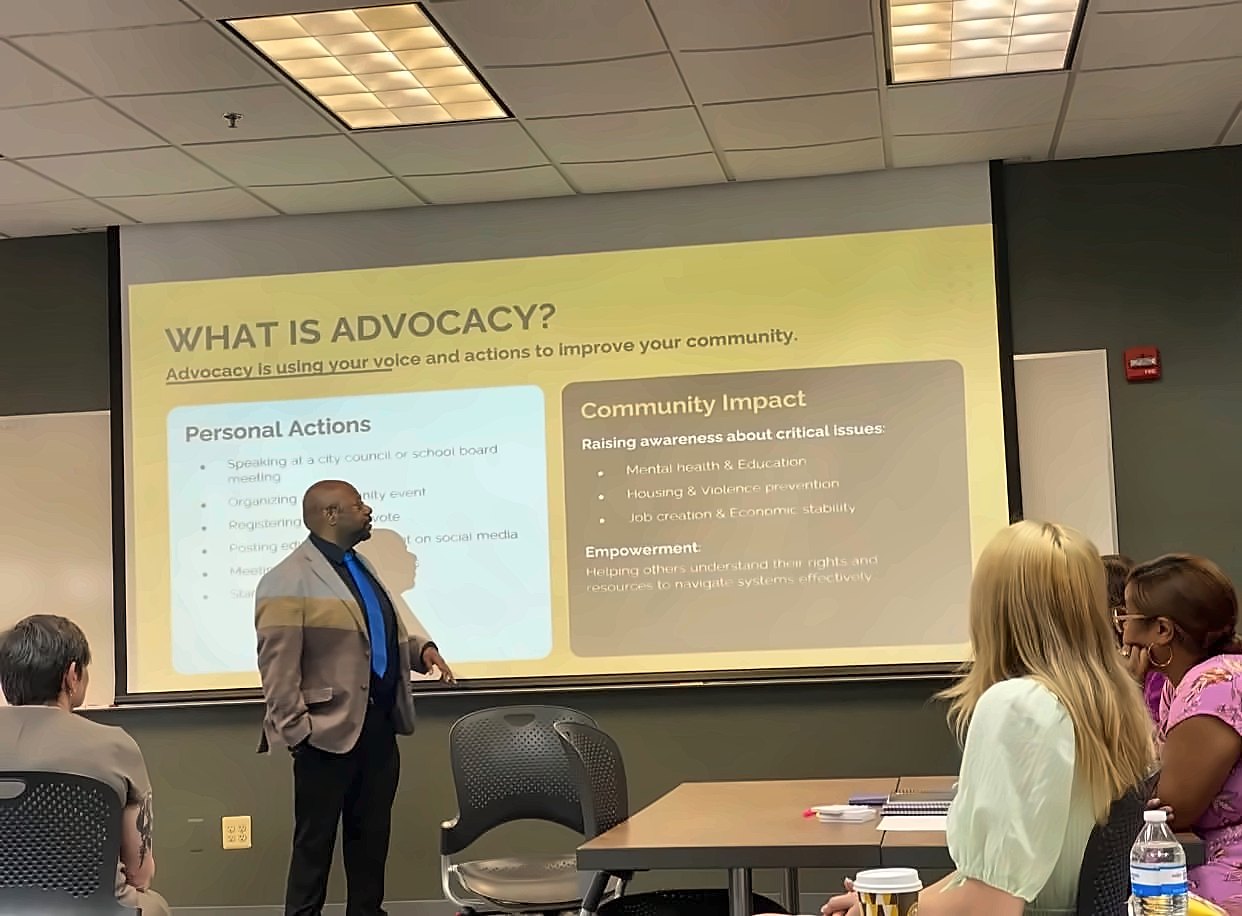 Kermit Williams presenting a What Is Advocacy slide to a workshop group