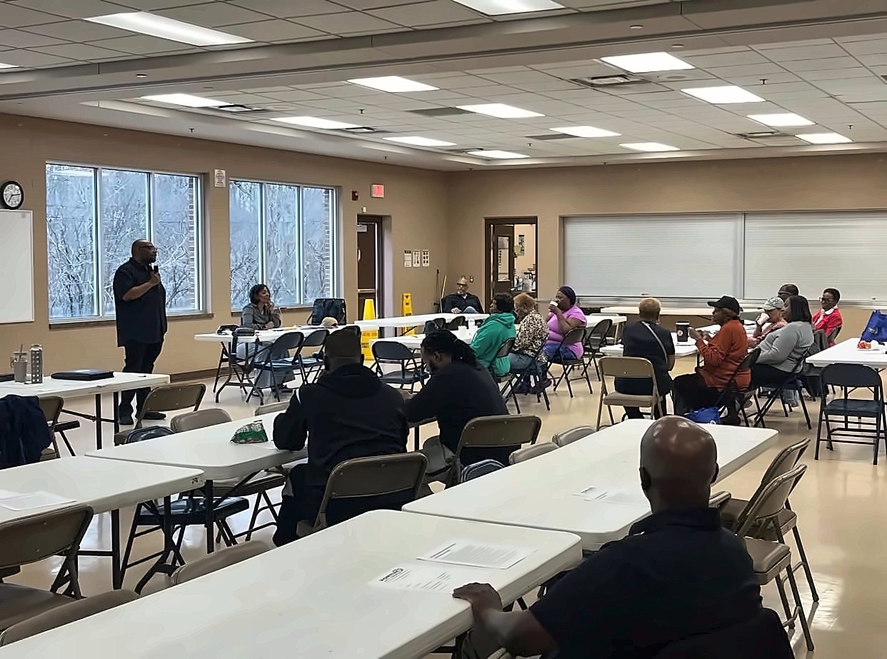 Kermit Williams leading a meeting in a community room